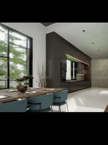 The dining area is positioned to offer serene views of the surrounding greenery through large windows. We use natural materials like the wooden dining table and earthy tones in the decor to complement the outdoor landscape.