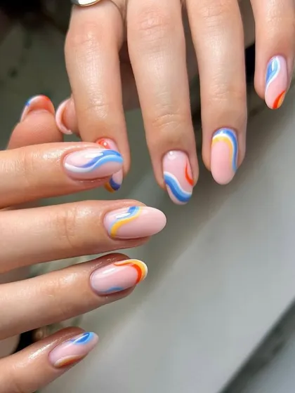 A playful abstract design with colorful swirls on a nude base, perfect for a pop of color.