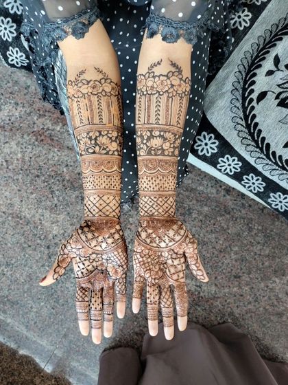 Another view of the engagement henna, showing the full length of the design from the palms to the forearms. The patterns are symmetrical but have unique details on each arm.