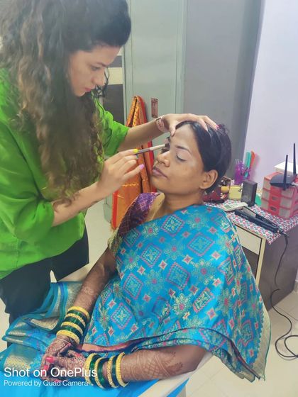 Here I am in action, carefully applying eye makeup. I believe in a collaborative process to create the perfect look for each bride.