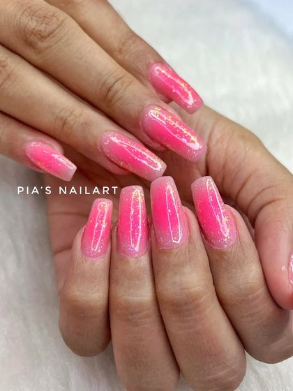 Pink aura nails with galaxy glitter flakes for a magical, out-of-this-world effect.