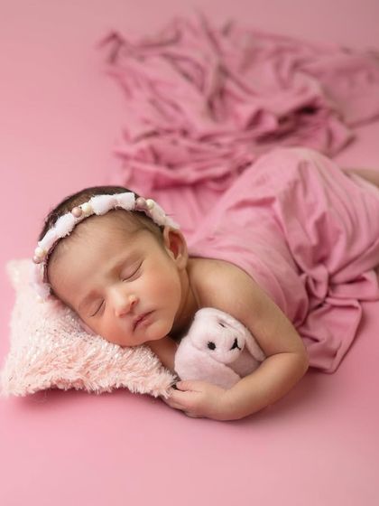 Most classy and most minimalist, that is our style. This simple side-lying pose on a soft pillow with a matching pink backdrop is elegant and beautiful.