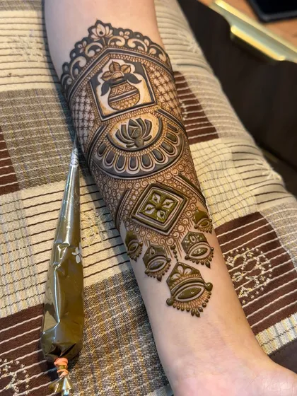 The nearly complete arm band, showing how all the elements like the kalash, lotus, and hanging bells come together.