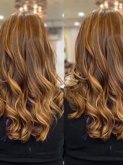 A stunning balayage with golden and caramel tones, styled in perfect, bouncy curls. This look is full of life and dimension.