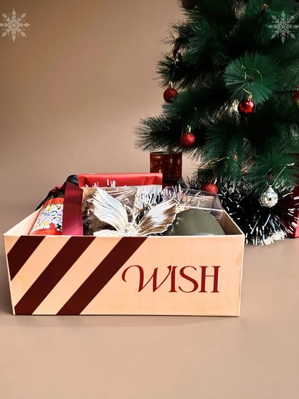 A side view of our "Holiday Crate" box, showing its cheerful and festive striped design.