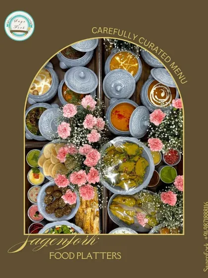 Our carefully curated food platters are perfect for gifting. This image shows a large assortment of our Indian and international dishes, beautifully arranged with flowers, ready to be delivered.