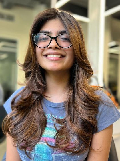 A smiling client is the best reward. Her new haircut and color have given her a fresh, happy glow.