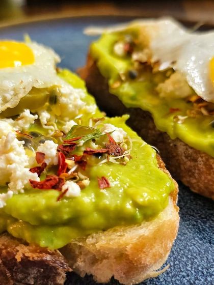 A beautiful close-up shot of the avocado toast, showing the rich colors and textures of the fresh ingredients.
