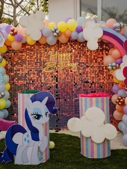 The main photo backdrop for the My Little Pony party, featuring a sparkling wall and character cutouts.