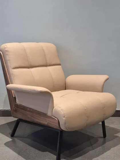 An angled view of the 'Enigma' chair, showcasing its comfortable depth and sophisticated design.