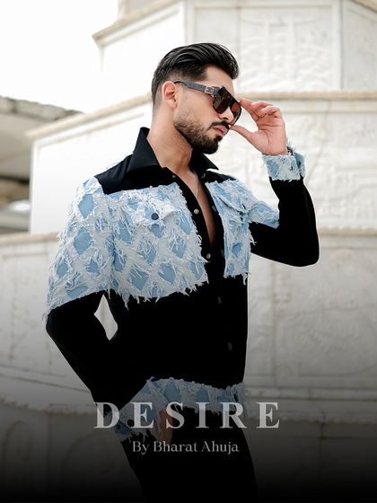 A close-up of the denim patchwork jacket, showcasing the frayed edges and textured details that give this piece its unique, rugged character.