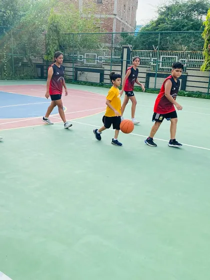 Players learn to move in a line, practicing dribbling and coordination.