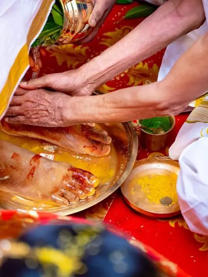 A close-up of the Kanyadaan ritual, where the bride's parents give her away, focusing on the hands and the symbolic act.