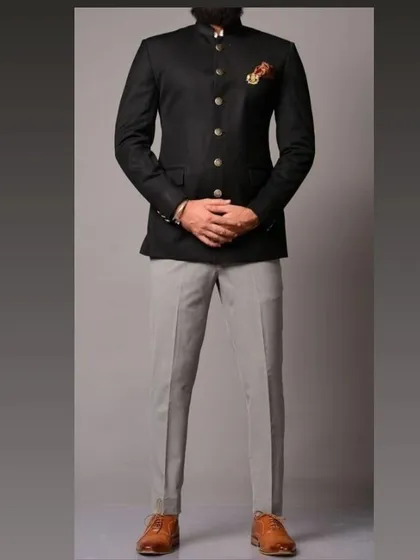 A timeless black bandhgala Jodhpuri suit paired with contrasting grey trousers. This is a versatile Indo-Western outfit I can tailor for any formal occasion, ensuring a perfect fit.