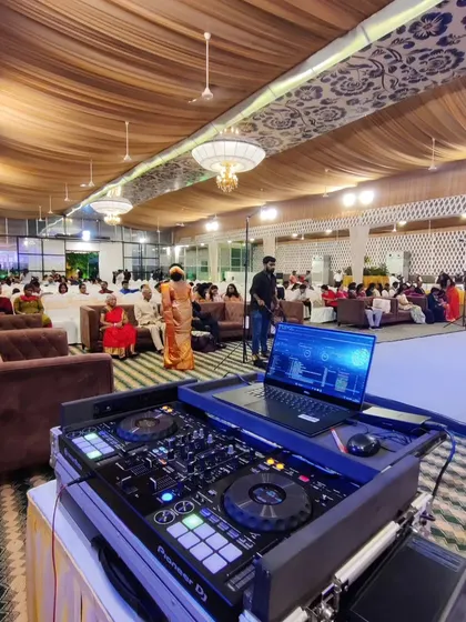 A wide view of the reception hall setup before guests fill the seats. This behind-the-scenes look shows the scale of the events I host and the importance of coordinating with the venue team.