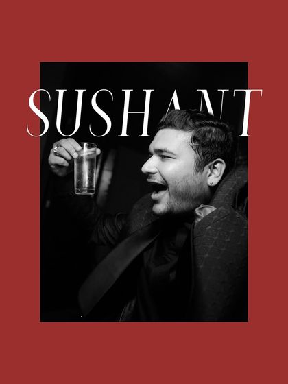 A stylish, graphic portrait of the groom, Sushant, enjoying the party. The black and white image with a red border gives it a modern, editorial feel.