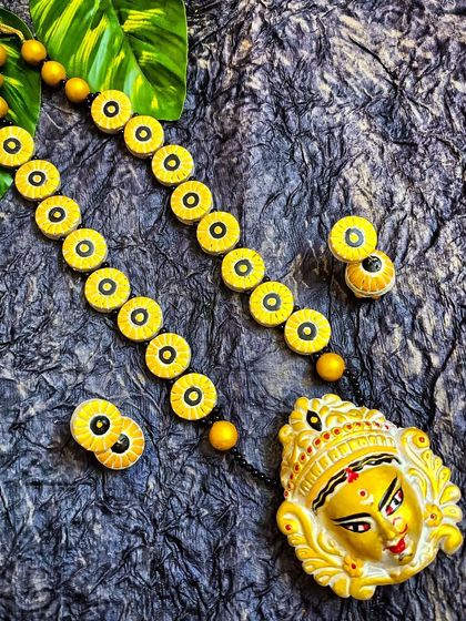 Celebrate the festive season with my Durga-themed long necklace. The pendant features a sculpted Durga face, and the chain is made of simple, circular beads, making the pendant the true centerpiece.