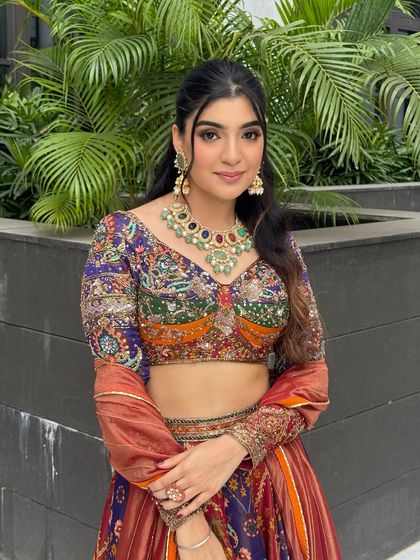 A close-up of the other sister, whose makeup features a slightly bolder eye to match the deeper tones in her outfit.