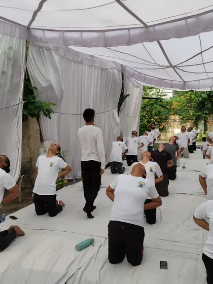 An indoor session where participants are practicing a gentle neck and shoulder stretch. We ensure our events cater to all needs, providing both energizing and restorative practices.