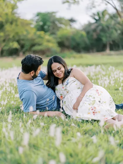 A relaxed and romantic moment, with the couple lying together in the grass. This perspective is intimate and sweet, surrounded by the softness of the field.