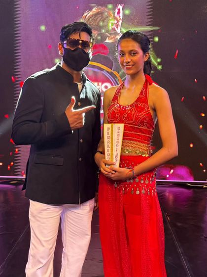 A proud moment with a student who reached the finals, holding her trophy. This is a huge achievement.