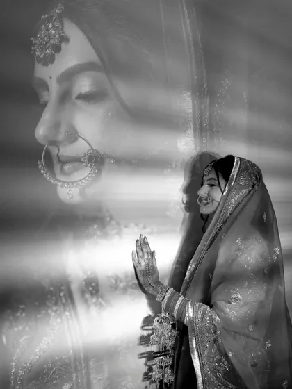 A creative double-exposure portrait of Vanaja, blending her profile with a prayerful pose, resulting in a spiritual and artistic image.
