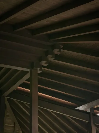 A detail of the intricate timber joinery in the roof structure of our Bali project. The craftsmanship celebrates the natural beauty and structural potential of wood, a material we deeply respect.