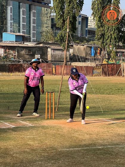 A woman in a pink jersey gets ready to hit the ball in a competitive PPL match.
