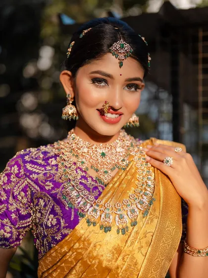 A smiling close-up portrait of actress Rachana Inder in a beautiful bridal saree. The shot captures her joy and the stunning details of her makeup and jewelry.