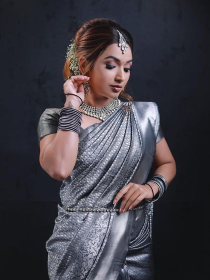 A demonstration look featuring a silver saree. This modern drape is perfect for evening events, creating a sleek and glamorous silhouette.