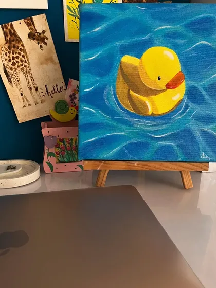 My duck painting sitting on a mini easel on my desk. These small canvases are perfect for adding a personal, artistic touch to your workspace.