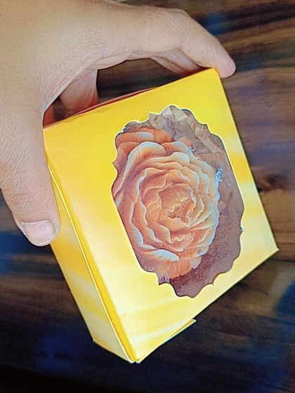 A new yellow box designed for packaging Ladoo candles or soaps. The window allows a peek at the beautiful product inside.