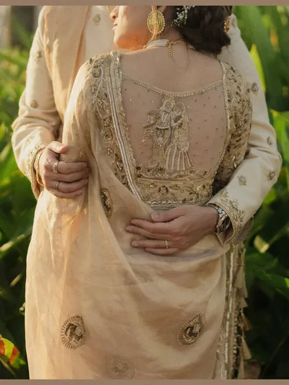 We believe beauty is in the details, like the intricate embroidery on a bride's blouse telling a story of its own. This close-up highlights the craftsmanship and personal touches that make a wedding day so special.