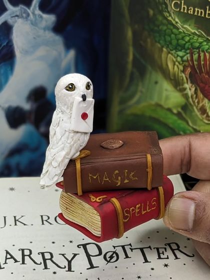 The Hedwig miniature placed against the backdrop of a Harry Potter book. It feels right at home.