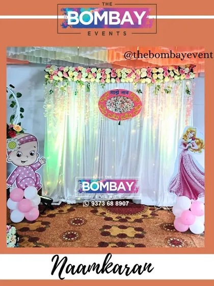 A traditional naming ceremony decoration with a 'Naamkaran' banner, fairy lights, and character cutouts. This setup is both classic and festive.
