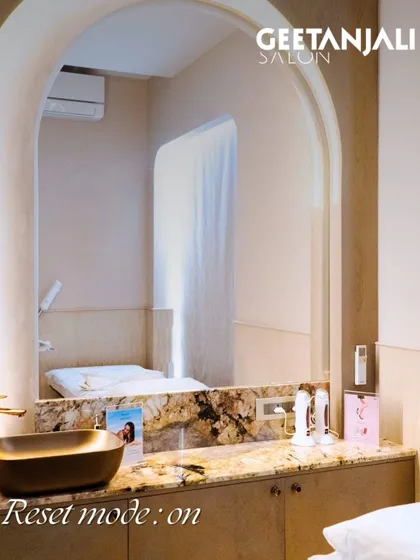 Reset mode: on. This is a view of one of our private treatment rooms, complete with a comfortable bed, elegant marble countertop, and modern fixtures, designed for facials and other skin care rituals.