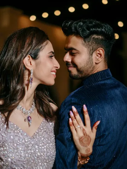 A close-up shot focusing on the couple's loving gaze, the bride's stunning jewelry, and the details of her engagement ring.