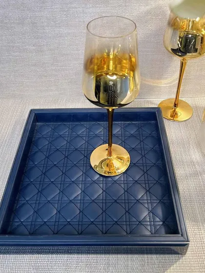 Elevate your decor with our luxurious Amadeus Bevelled Glass Tray. Crafted with a blue leather interior and a quilted pattern, it's a sophisticated piece for serving drinks or organizing items on a console table.
