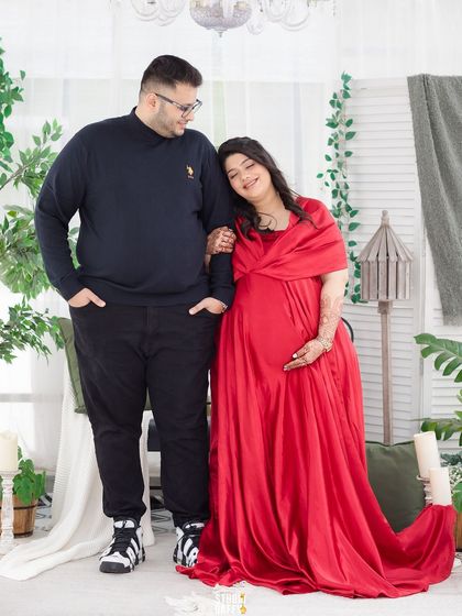 A sweet and loving moment between the expectant couple, with the mother-to-be leaning on her partner's shoulder.