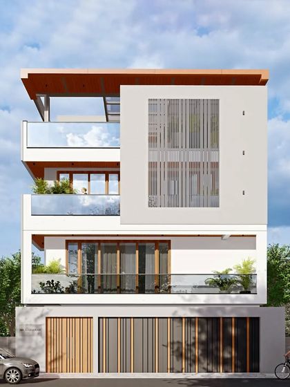 A 4BHK luxury residence in South Bengaluru. This contemporary design features a clean white facade, extensive use of glass for balconies, and wooden louvers for privacy and sun shading.