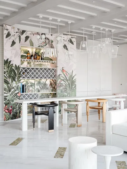Revisiting House No. 7 and its incredible Reveal Bar. The all-white dining area provides a stark, beautiful contrast to the burst of color hidden within the bar.