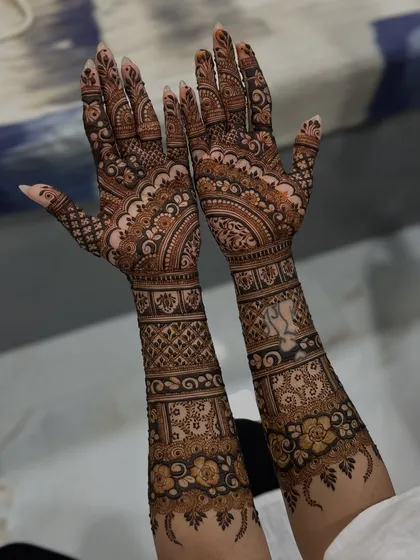The back of the hands, showing how the intricate design continues all the way around the arm.
