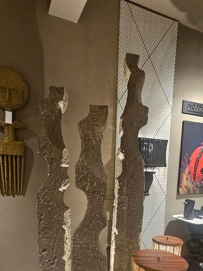 Abstract, human-form sculptures in a rough, stone-like finish, perfect for adding an artistic touch to a modern interior or exterior space.