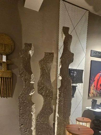 Abstract, human-form sculptures in a rough, stone-like finish, perfect for adding an artistic touch to a modern interior or exterior space.