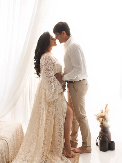 An intimate portrait filled with anticipation. The high-key lighting and their close embrace create a dreamy, romantic image that focuses purely on their connection.