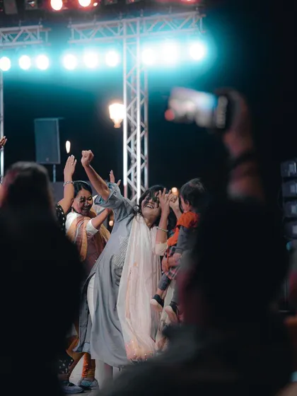 An audience member dances with pure, uninhibited joy at a live concert. For me, the crowd's energy is just as important as the performance on stage, and I'm always looking for these authentic moments.