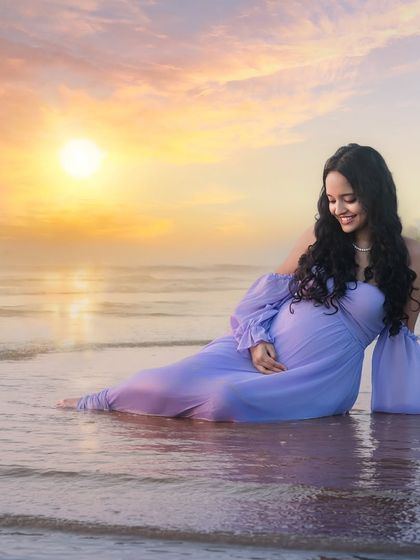 Soaking in the moment. Seated in the gentle surf as the sun sets, this portrait captures a feeling of complete peace and connection with nature.