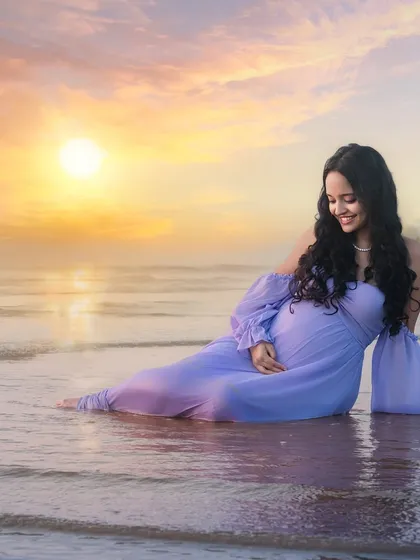 Soaking in the moment. Seated in the gentle surf as the sun sets, this portrait captures a feeling of complete peace and connection with nature.