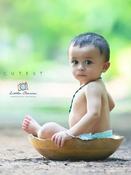 This classic sitter portrait captures the direct gaze and innocent curiosity of a baby exploring the world.