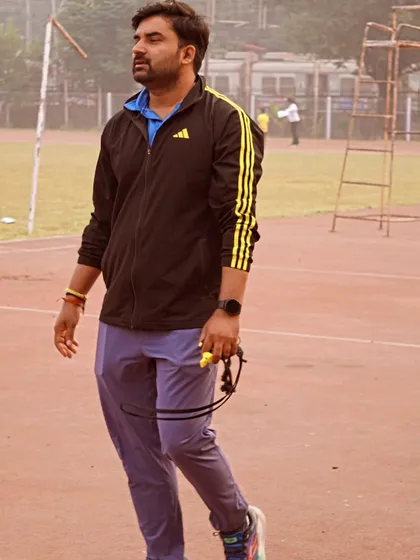 Walking the track with my stopwatch, ready for the next set of drills.